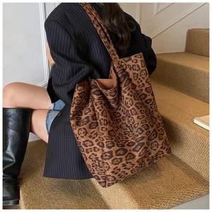 Close-up of leopard print tote bag with soft velvet texture and wide shoulder strap