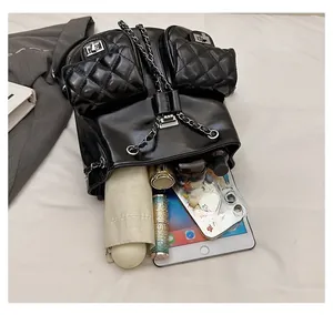Top view of large black quilted backpack showing internal capacity for daily essentials