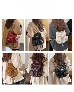 Quilted backpack featuring adjustable chain straps and a classic turn-lock metal closure