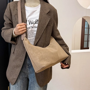 Detail view of large khaki hobo bag featuring retro matte texture and vertical stitching