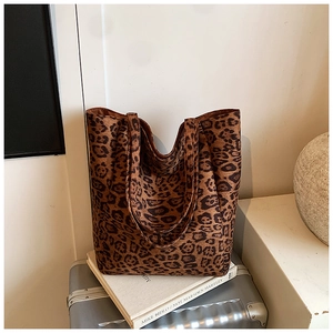 Macro detail of soft leopard print suede texture on a large capacity tote bag