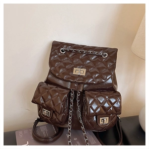 Detail of rhombic quilted backpack with metal swivel lock and chain drawstring closure