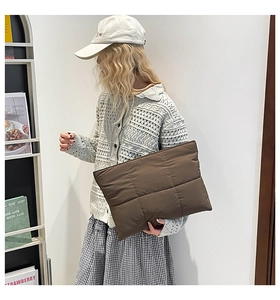 Detailed view of the dark brown quilted nylon clutch featuring classic lattice stitching