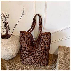 Detail of leopard print tote bag showing soft plush texture and large capacity design