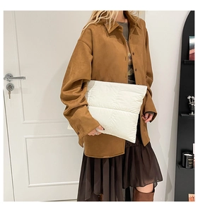 Fashionable white quilted cloud bag styled with brown casual autumn winter outfit