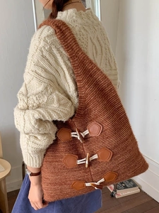 Brown chunky knit tote bag with vintage toggle buttons shown on model's shoulder