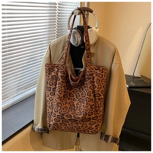 Close-up of leopard print tote bag texture and spacious capacity for daily shoulder use
