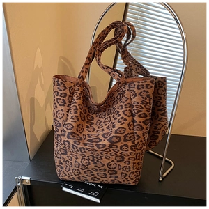 Detailed close-up of leopard print tote bag with soft texture and sturdy dual handles