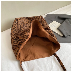 Macro detail of leopard print tote bag showing rich texture and brown inner lining