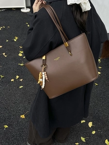 Vintage brown leather tote bag with colorful beaded tassel pendant and fashion logo