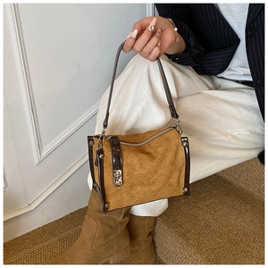 Detailed view of ginger square handbag featuring quilted suede and contrast leather trim