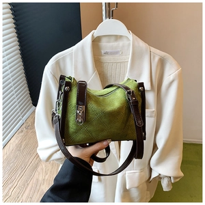 Detail of green suede crossbody bag with rhombus embossing and leather strap