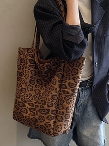 Chic leopard print tote bag with large capacity in suede texture worn by a model