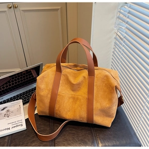 Minimalist ginger suede tote bag with brown leather handles in a cozy office setting