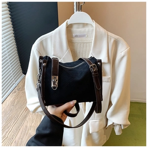 Close-up of black crossbody bag with brown faux leather strap and silver swivel lock