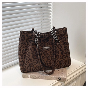 Detailed close-up of brown leopard print tote bag with silver chain strap and brand label