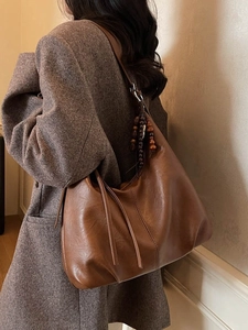 Brown vintage hobo shoulder bag with tassel and bead charm for daily winter wear