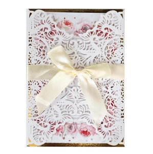 Elegant laser cut wedding invitation with floral insert and cream silk ribbon bow