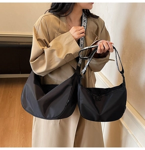 Comparison of large and small nylon dumpling bags with geometric jacquard straps