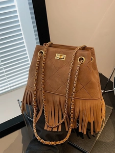 Vintage brown suede bucket bag with quilted patterns, fringe details, and a gold chain strap