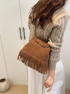 Vintage brown suede fringe bucket bag with diamond stitching and golden chain strap