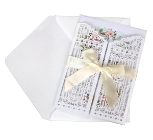 Laser cut wedding invitation set with floral inner card and white satin ribbon bow