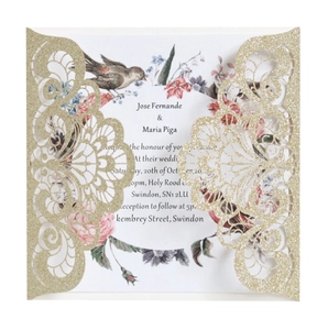 Detail of laser-cut gold glitter wedding invitation with elegant floral pattern
