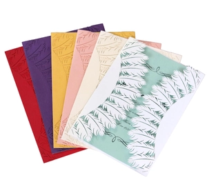 Detailed laser-cut feather pattern on wedding invitations in six vibrant color options