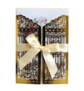 Detailed laser-cut gatefold wedding invitation with gold lace and ribbon bow