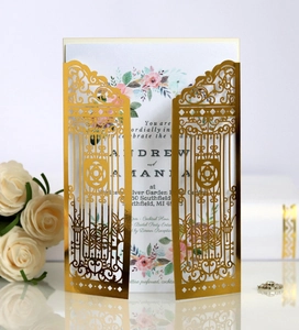 Intricate laser-cut gold lace gate wedding invitation with floral inner card detail