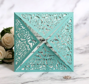 Detail of laser-cut rose hollow design on mint green wedding invitation with pearlescent finish