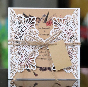 Laser-cut wedding invitations with rustic kraft paper, floral design and twine