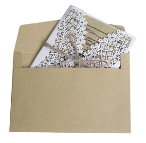 Laser-cut floral wedding invitation set with kraft paper inner card and jute twine bow