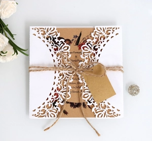 Laser cut lace wedding invitation with kraft paper insert and decorative twine bow