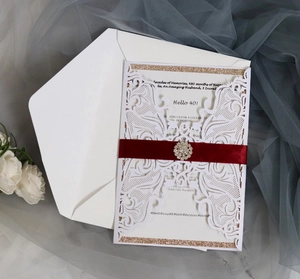 Laser-cut birthday invitation with Hello 40, pink lace, red ribbon, and rhinestone buckle