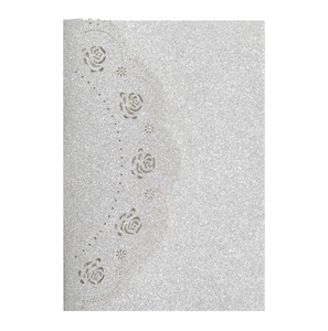 Macro detail of laser-cut rose patterns on silver glitter cardstock invitation cover