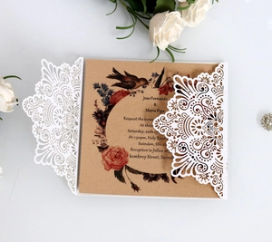 Laser cut white wedding invitation with rustic kraft card and vintage floral illustration