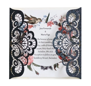 Detail of laser-cut black glitter wedding invitation with elegant floral inner card