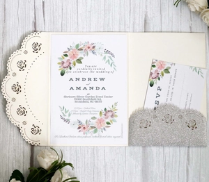 Detail of laser-cut rose wedding invitation set with glitter RSVP card and floral insert