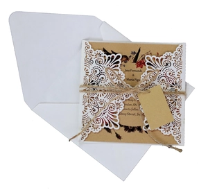 Laser cut floral wedding invitation with kraft paper card and rustic twine bow