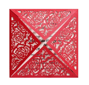 Close-up of red laser cut rose hollow wedding invitation with white paper insert