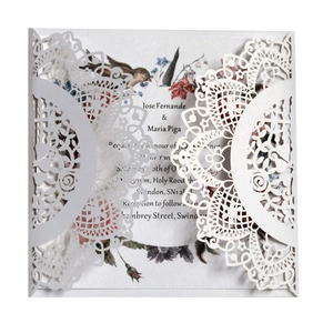 Detailed laser cut white pearlescent paper wedding invitation with floral inner card