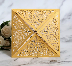 Macro detail of laser-cut gold rose pattern on luxury wedding invitation sleeve