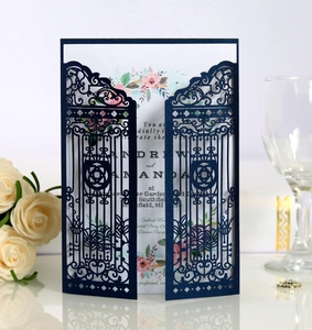 Detail of laser-cut navy blue gate wedding invitation with floral watercolor insert