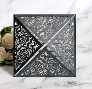 Detailed laser-cut rose patterns on elegant black pearl paper wedding invitation cover