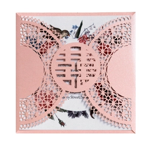 Pink laser-cut wedding invitation with hollow Double Happiness design and floral insert