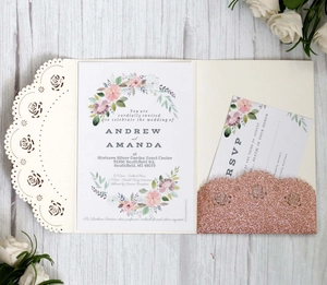 Detail of laser-cut wedding invitation set with floral inner cards and glitter pocket