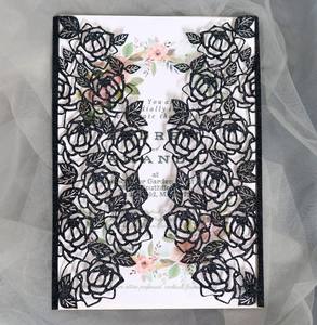 Détail du faire-part de mariage noir à paillettes découpé au laser avec insert floral