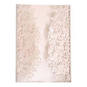 Detailed laser-cut rose patterns on pearlescent pink wedding invitation paper