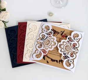 Detailed laser cut wedding invitation covers with floral kraft paper inner sheets